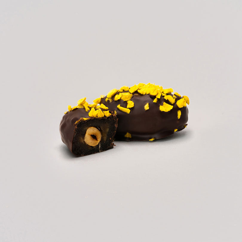 Un paquete de 12 dátiles Medjool rellenos de frutos secos y cubiertos con 100% cacao